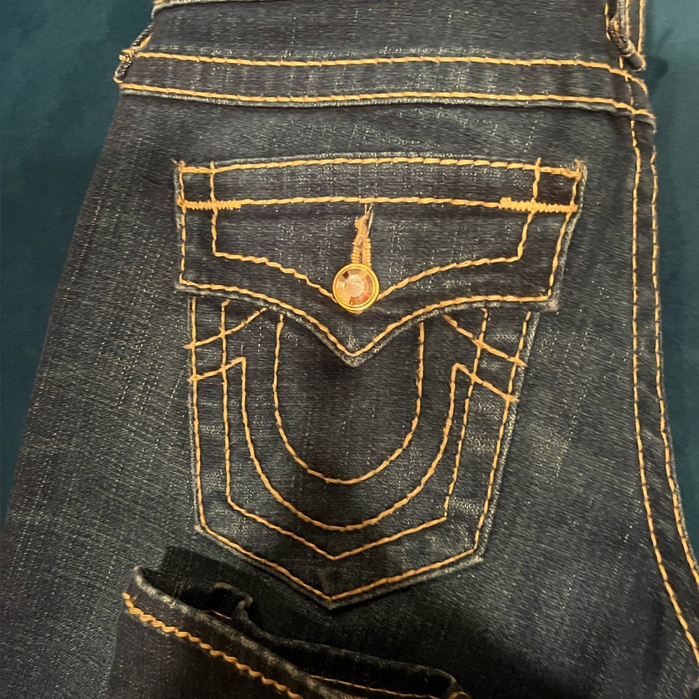 Dark wash skinny true religion jeans with gold accents